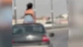 Seyir halindeki otomobilin kaputuna oturan kadın ve sürücü gözaltına alındı