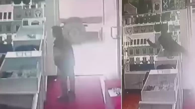 Masanın üstüne çıkıp vitrindeki telefonları alarak kaçtı
