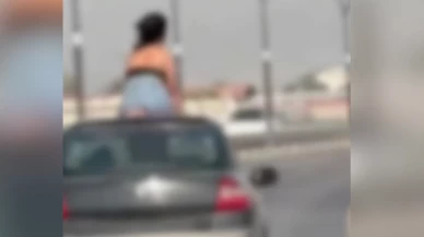 Seyir halindeki otomobilin kaputuna oturan kadın ve sürücü gözaltına alındı